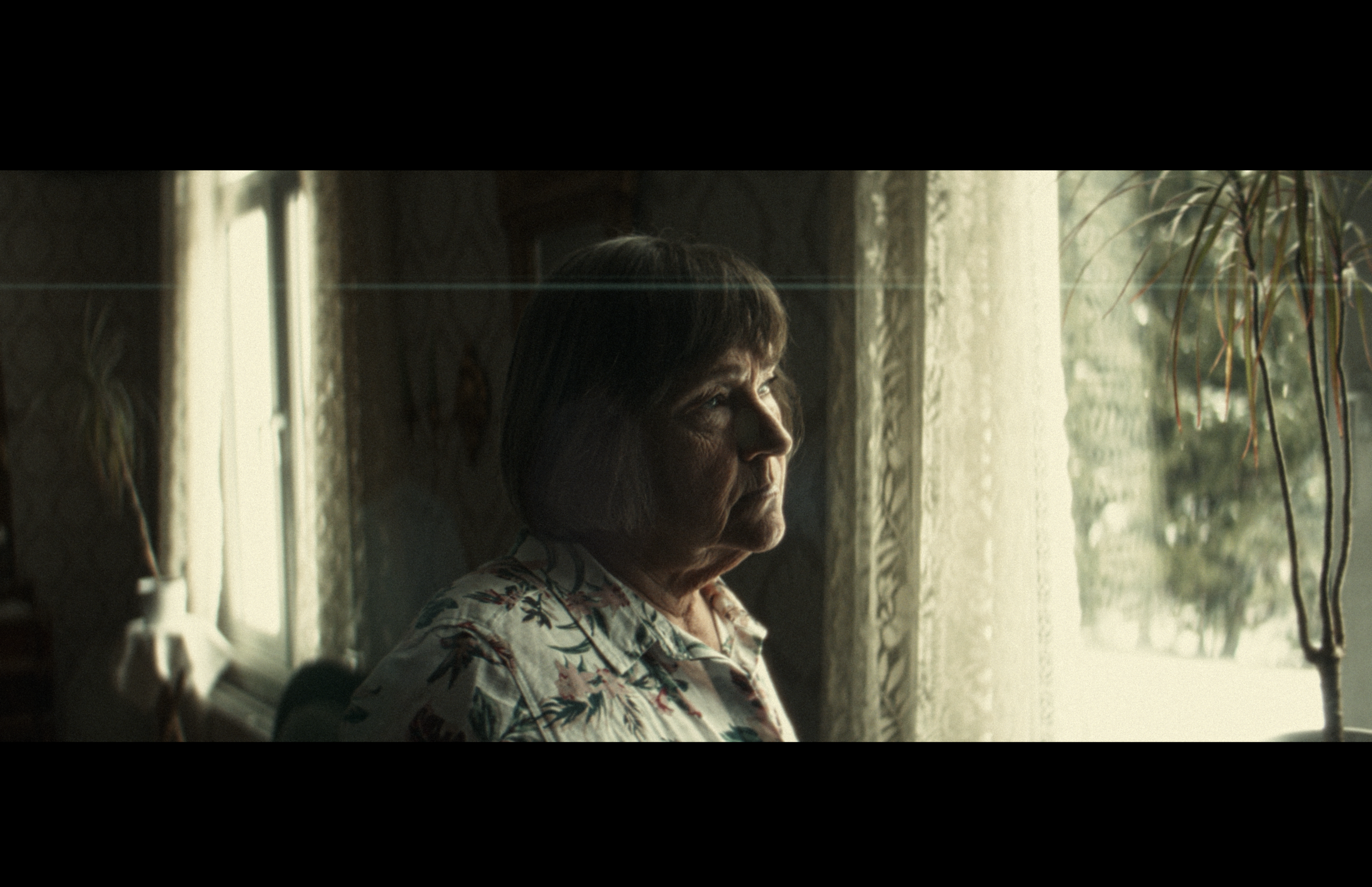 Phos — window-light portrait with lens flare